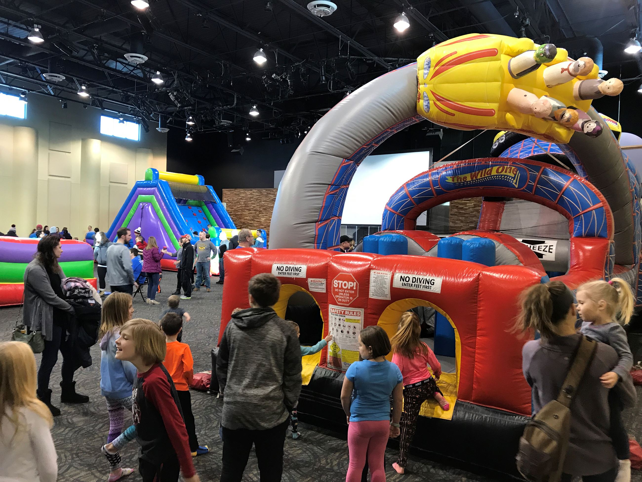 Image of kids and inflatable bounce houses.