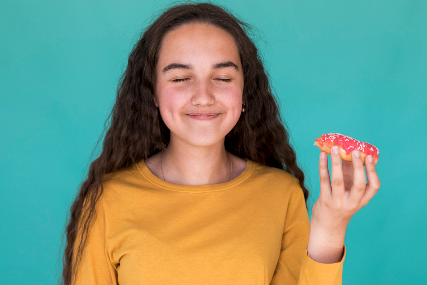 Image of a girl eating a donut.