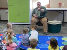 Image of staff from Dallas County Conservation reading to kids.